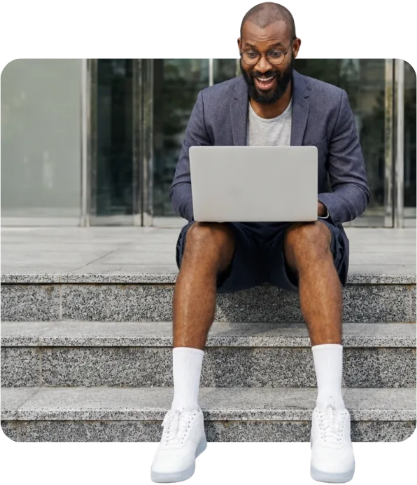 Compliance specialist working on a laptop on office steps
