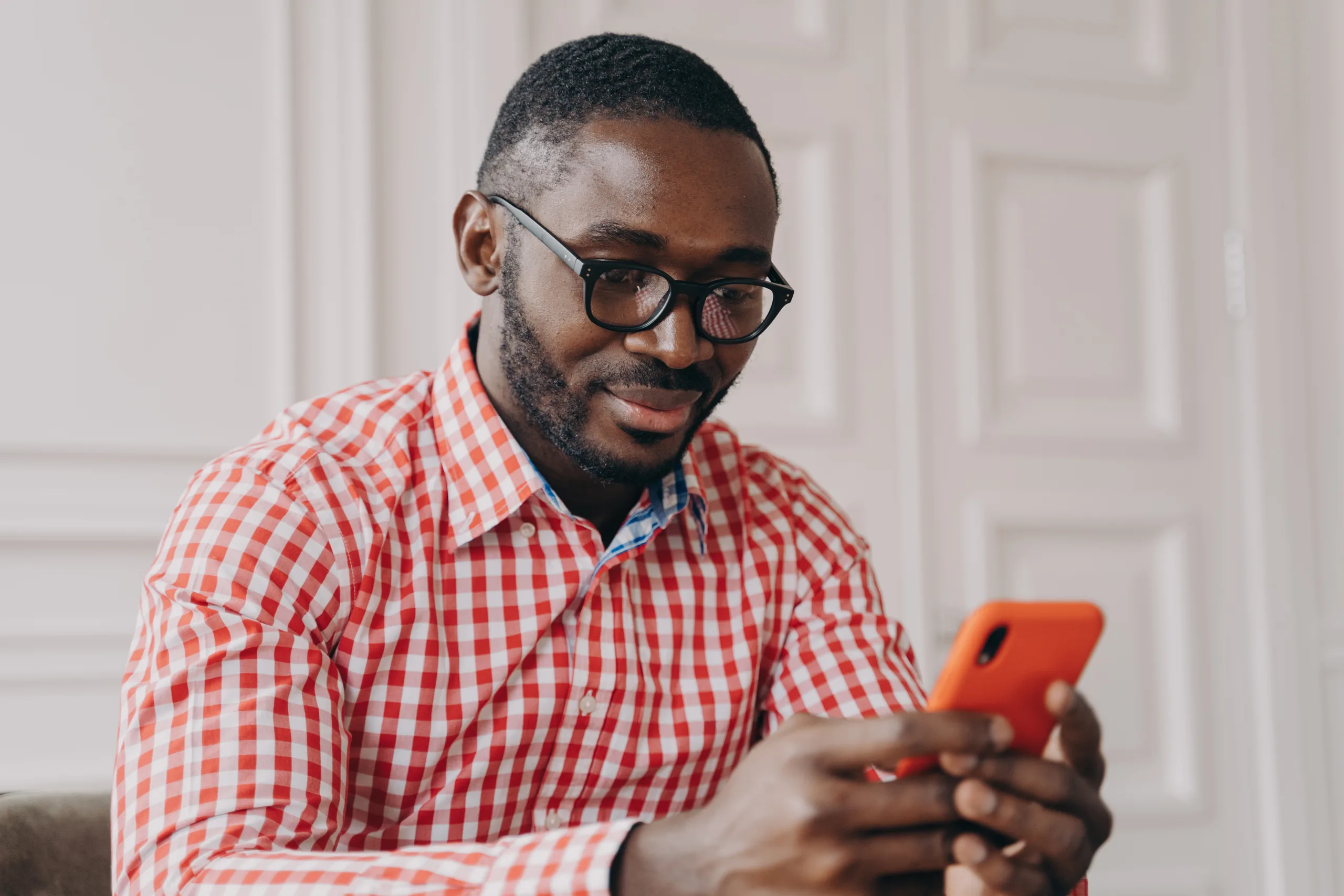 A man reviewing an identity verification prompt on his smartphone while seated at his desk